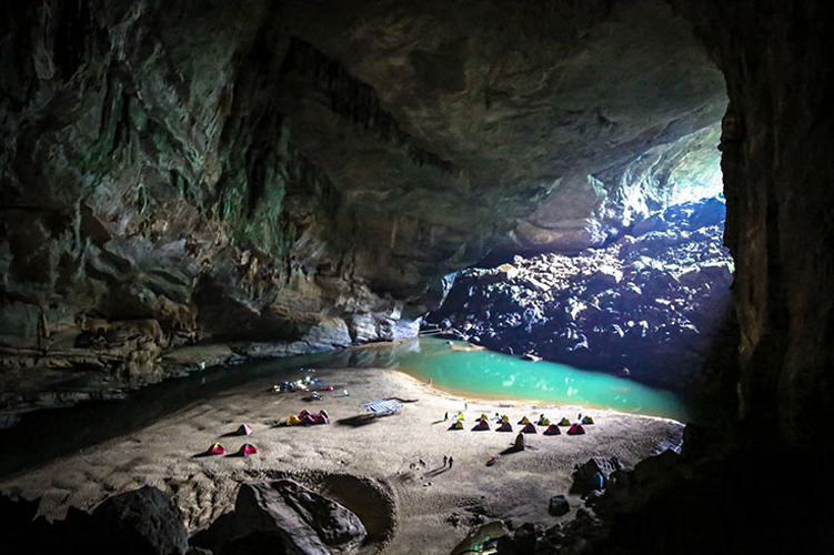 tents-and-small-people-in-a-cave-vietnam-parinazbilimoria